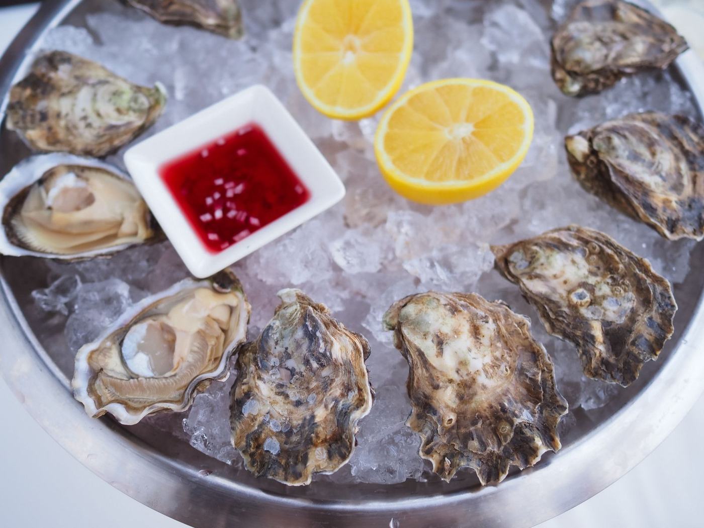 A dozen oysters on crushed ice with mignonette and lemon at The Shuck